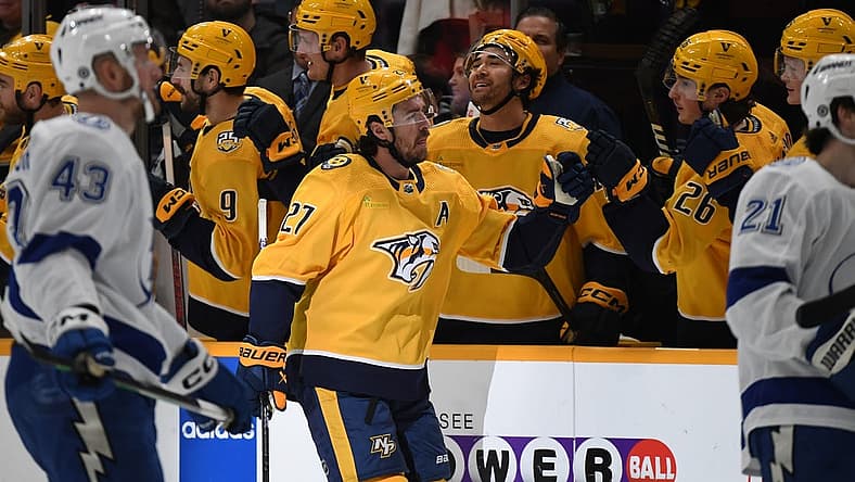 Dec 7, 2023; Nashville, Tennessee, USA; Nashville Predators defenseman Ryan McDonagh (27) is congratulated by teammates after a goal during the second period against the Tampa Bay Lightning at Bridgestone Arena. Mandatory Credit: Christopher Hanewinckel-USA TODAY Sports