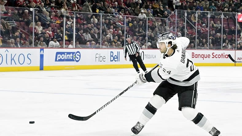 Dec 7, 2023; Montreal, Quebec, CAN; Los Angeles Kings forward Philllip Danault (24) takes a shot on the Montreal Canadiens net during the third period at the Bell Centre. Mandatory Credit: Eric Bolte-USA TODAY Sports