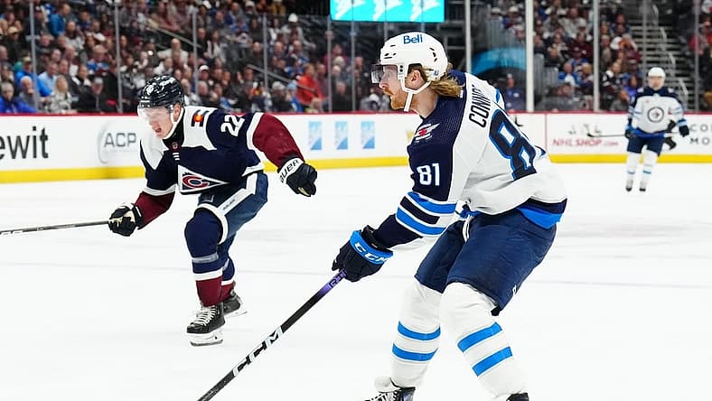 Dec 7, 2023; Denver, Colorado, USA; Winnipeg Jets left wing Kyle Connor (81) shoots the puck in the second period against the Colorado Avalanche at Ball Arena. Mandatory Credit: Ron Chenoy-USA TODAY Sports