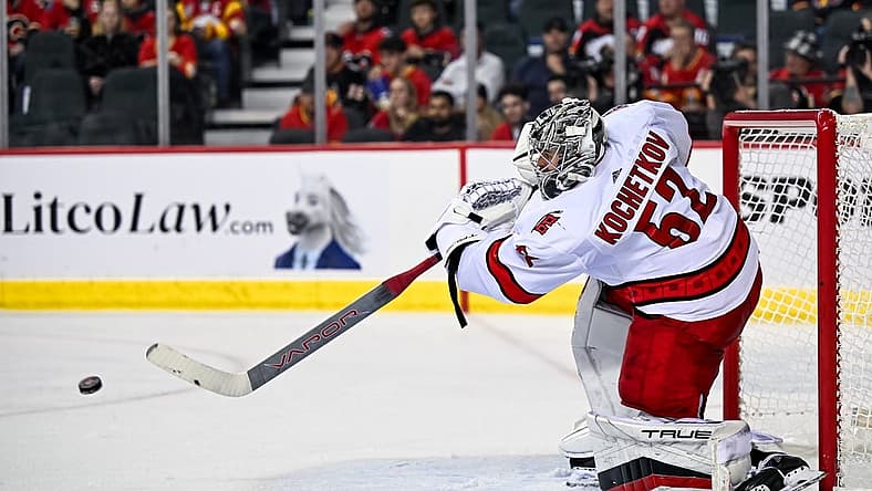 Dec 7, 2023; Calgary, Alberta, CAN; Carolina Hurricanes goaltender Pyotr Kochetkov (52) passes the puck during the third period of a game against the Calgary Flames at Scotiabank Saddledome. Mandatory Credit: Brett Holmes-USA TODAY Sports