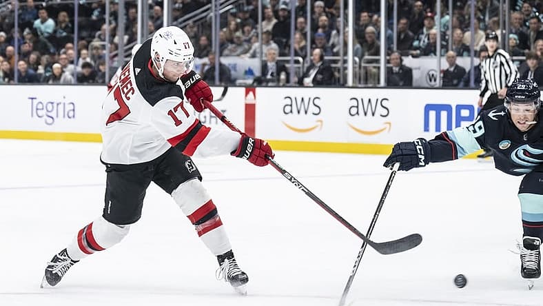 Dec 7, 2023; Seattle, Washington, USA; New Jersey Devils defenseman Simon Nemec (17) takes a shot against defenseman Vince Dunn (29) during the first period at Climate Pledge Arena. Mandatory Credit: Stephen Brashear-USA TODAY Sports