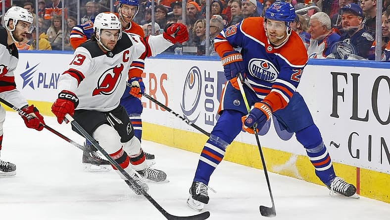Dec 10, 2023; Edmonton, Alberta, CAN; Edmonton Oilers forward Leon Draisaitl (29) makes pass in front of to f New Jersey Devils forward Nico Hischier (13) during the first period at Rogers Place. Mandatory Credit: Perry Nelson-USA TODAY Sports