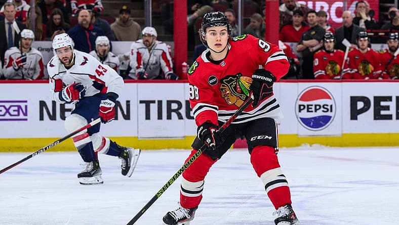 Dec 10, 2023; Chicago, Illinois, USA; Chicago Blackhawks center Connor Bedard (98) passes the puck against the Washington Capitals during the first period at the United Center. Mandatory Credit: Daniel Bartel-USA TODAY Sports