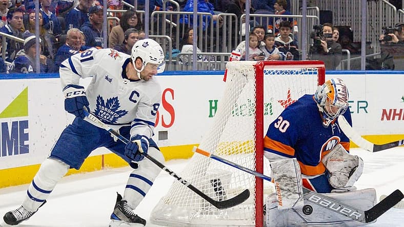 Dec 11, 2023; Elmont, New York, USA; Toronto Maple Leafs center John Tavares (91) takes a shot while New York Islanders goaltender Ilya Sorokin (30) makes the save during the third period at UBS Arena. Mandatory Credit: Thomas Salus-USA TODAY Sports