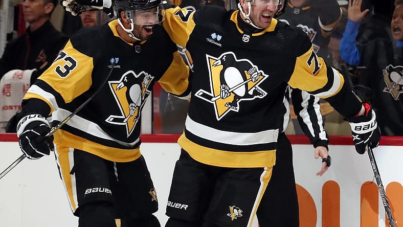 Dec 12, 2023; Pittsburgh, Pennsylvania, USA; Pittsburgh Penguins center Jeff Carter (77) reacts with defenseman Pierre-Olivier Joseph (73) after Carter scored a short-handed goal against the Arizona Coyotes during the first period at PPG Paints Arena. Pittsburgh won 4-2. Mandatory Credit: Charles LeClaire-USA TODAY Sports