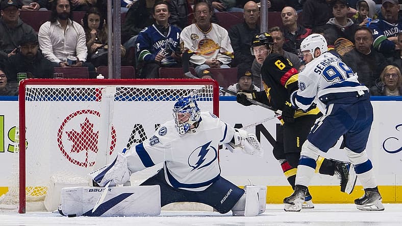 Dec 12, 2023; Vancouver, British Columbia, CAN; Vancouver Canucks forward Brock Boeser (6) and Tampa Bay Lightning defenseman Mikhail Sergachev (98) watch as goalie Andrei Vasilevskiy (88) makes a save in the first period at Rogers Arena. Mandatory Credit: Bob Frid-USA TODAY Sports