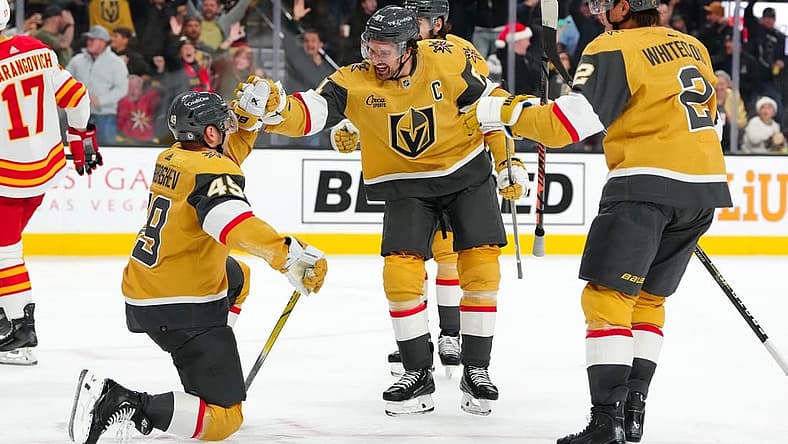 Dec 12, 2023; Las Vegas, Nevada, USA; Vegas Golden Knights center Ivan Barbashev (49) celebrates with Vegas Golden Knights right wing Mark Stone (61) and Vegas Golden Knights defenseman Zach Whitecloud (2) after scoring a goal against the Calgary Flames during the second period at T-Mobile Arena. Mandatory Credit: Stephen R. Sylvanie-USA TODAY Sports