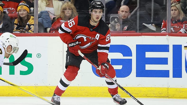 Dec 13, 2023; Newark, New Jersey, USA; New Jersey Devils center Jack Hughes (86) skates with the puck during the third period against the Boston Bruins at Prudential Center. Mandatory Credit: Vincent Carchietta-USA TODAY Sports