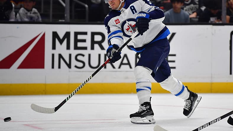 Dec 13, 2023; Los Angeles, California, USA; Winnipeg Jets center Mark Scheifele (55) shoots on goal against the Los Angeles Kings during the third period at Crypto.com Arena. Mandatory Credit: Gary A. Vasquez-USA TODAY Sports