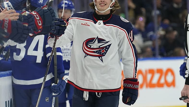 Dec 14, 2023; Toronto, Ontario, CAN; Columbus Blue Jackets forward Kent Johnson (91) gets congratulated after scoring against the Toronto Maple Leafs during the first period at Scotiabank Arena. Mandatory Credit: John E. Sokolowski-USA TODAY Sports