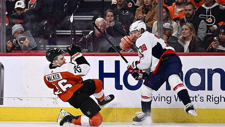 Dec 14, 2023; Philadelphia, Pennsylvania, USA; Philadelphia Flyers defenseman Sean Walker (26) collides with Washington Capitals defenseman Rasmus Sandin (38) in the first period at Wells Fargo Center. Mandatory Credit: Kyle Ross-USA TODAY Sports