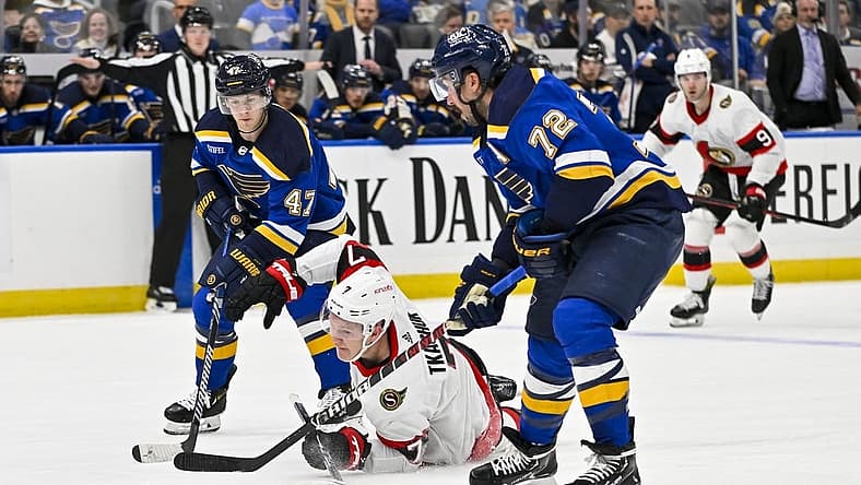 Dec 14, 2023; St. Louis, Missouri, USA;  Ottawa Senators left wing Brady Tkachuk (7) falls to the ice as St. Louis Blues defenseman Torey Krug (47) and defenseman Justin Faulk (72) defend during the first period at Enterprise Center. Mandatory Credit: Jeff Curry-USA TODAY Sports