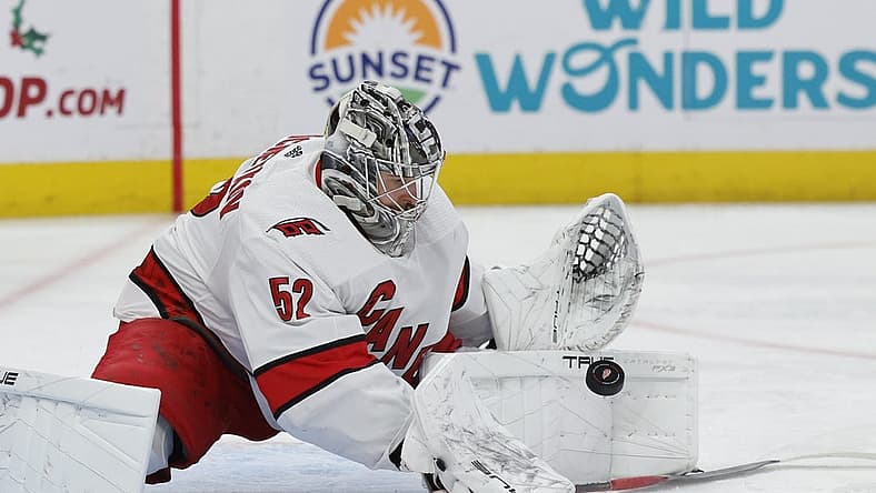 Dec 14, 2023; Detroit, Michigan, USA; Carolina Hurricanes goaltender Pyotr Kochetkov (52) makes a save in the second period against the Detroit Red Wings at Little Caesars Arena. Mandatory Credit: Rick Osentoski-USA TODAY Sports