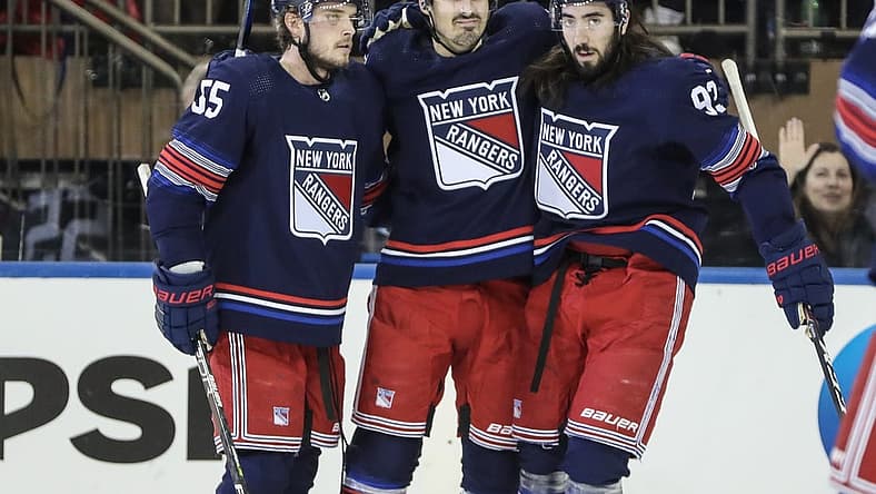 Dec 15, 2023; New York, New York, USA; New York Rangers left wing Chris Kreider (20) is greeted by defenseman Ryan Lindgren (55) and center Mika Zibanejad (93) after scoring a goal in the first period against the Anaheim Ducks at Madison Square Garden. Mandatory Credit: Wendell Cruz-USA TODAY Sports