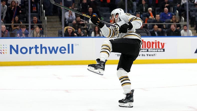 Dec 15, 2023; Elmont, New York, USA; Boston Bruins right wing David Pastrnak (88) follows through on the game winning goal during the shootout at UBS Arena. Mandatory Credit: Brad Penner-USA TODAY Sports