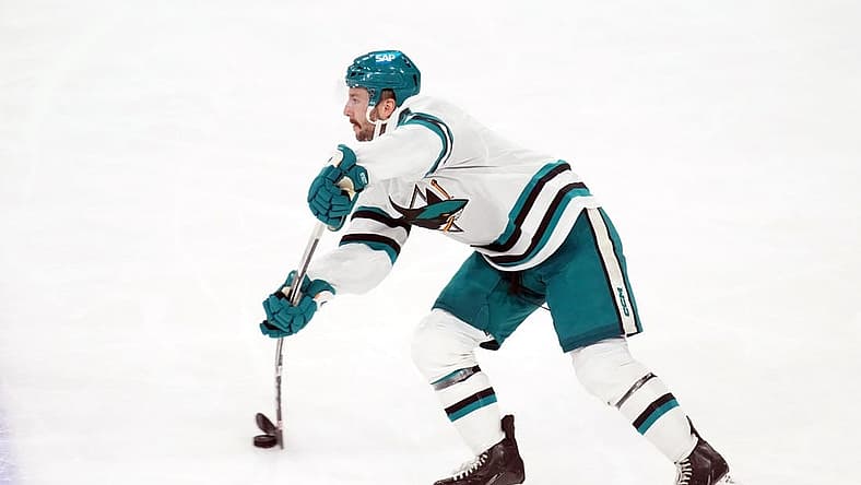 Dec 15, 2023; Tempe, Arizona, USA; San Jose Sharks defenseman Kyle Burroughs (4) passes the puck against the Arizona Coyotes during the third period at Mullett Arena. Mandatory Credit: Joe Camporeale-USA TODAY Sports