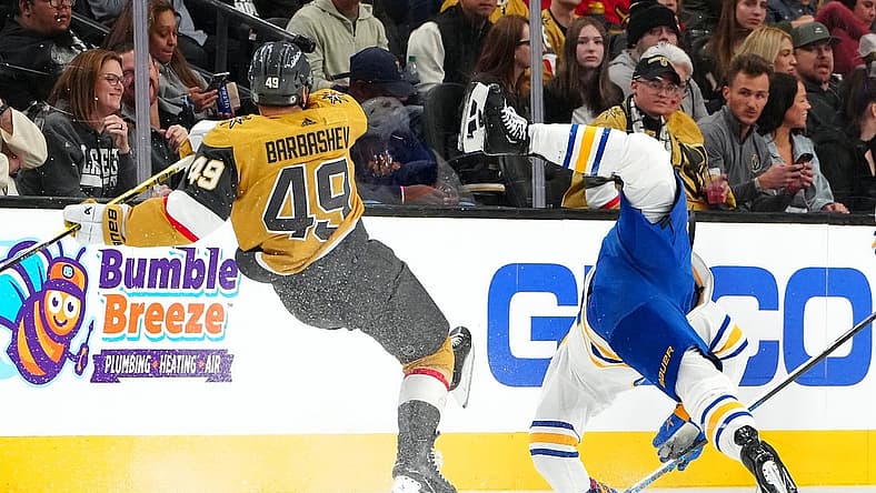 Dec 15, 2023; Las Vegas, Nevada, USA; Vegas Golden Knights center Ivan Barbashev (49) checks Buffalo Sabres center Dylan Cozens (24) during the second period at T-Mobile Arena. Mandatory Credit: Stephen R. Sylvanie-USA TODAY Sports