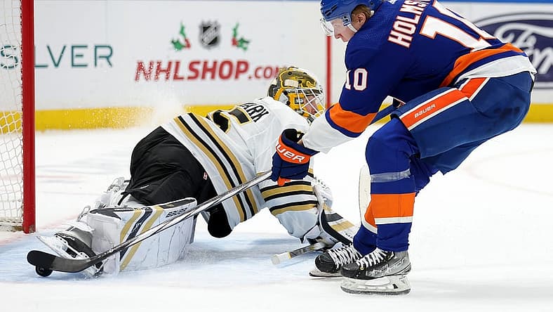 Dec 15, 2023; Elmont, New York, USA; New York Islanders right wing Simon Holmstrom (10) scores a goal against Boston Bruins goaltender Linus Ullmark (35) during the second period at UBS Arena. Mandatory Credit: Brad Penner-USA TODAY Sports