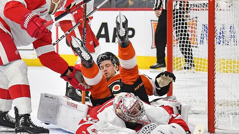 Dec 16, 2023; Philadelphia, Pennsylvania, USA; Philadelphia Flyers left wing Joel Farabee (86) lands on top of Detroit Red Wings goaltender Alex Lyon (34) during the first period at Wells Fargo Center. Mandatory Credit: Eric Hartline-USA TODAY Sports