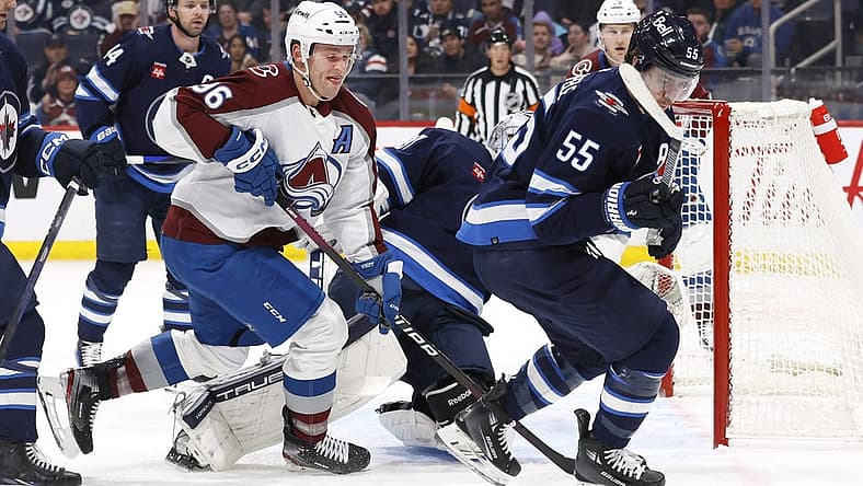 Dec 16, 2023; Winnipeg, Manitoba, CAN; Colorado Avalanche right wing Mikko Rantanen (96) and Winnipeg Jets center Mark Scheifele (55) chase after the puck in the first period at Canada Life Centre. Mandatory Credit: James Carey Lauder-USA TODAY Sports