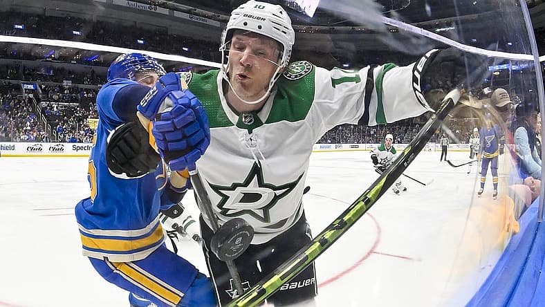 Dec 16, 2023; St. Louis, Missouri, USA;  Dallas Stars center Ty Dellandrea (10) and St. Louis Blues defenseman Tyler Tucker (75) battle for the puck during the first period at Enterprise Center. Mandatory Credit: Jeff Curry-USA TODAY Sports