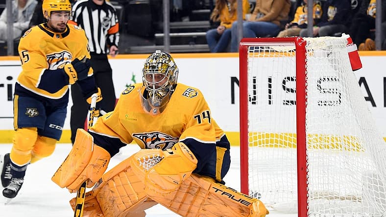 Dec 16, 2023; Nashville, Tennessee, USA; Nashville Predators goaltender Juuse Saros (74) watches a shot deflect into the corner during the second period against the Washington Capitals at Bridgestone Arena. Mandatory Credit: Christopher Hanewinckel-USA TODAY Sports