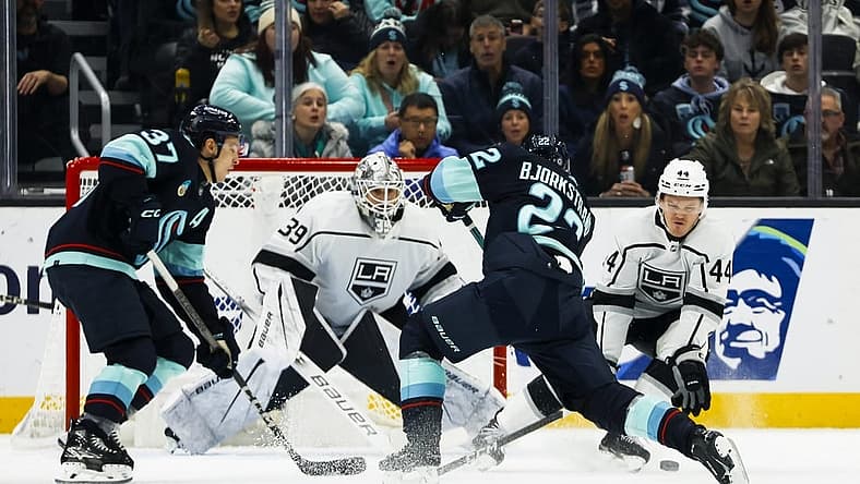Dec 16, 2023; Seattle, Washington, USA; Los Angeles Kings defenseman Mikey Anderson (44) blocks a shot by Seattle Kraken right wing Oliver Bjorkstrand (22) during the first period at Climate Pledge Arena. Seattle Kraken center Yanni Gourde (37) and Los Angeles Kings goaltender Cam Talbot (39) follow the play at left. Mandatory Credit: Joe Nicholson-USA TODAY Sports
