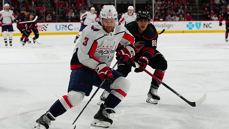 Dec 17, 2023; Raleigh, North Carolina, USA;  Washington Capitals defenseman Nick Jensen (3) skates with the puck past Carolina Hurricanes left wing Teuvo Teravainen (86) during the first period at PNC Arena. Mandatory Credit: James Guillory-USA TODAY Sports