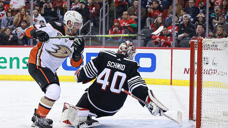 Dec 17, 2023; Newark, New Jersey, USA; Anaheim Ducks center Adam Henrique (14) scores a goal past New Jersey Devils goaltender Akira Schmid (40) during the second period at Prudential Center. Mandatory Credit: Vincent Carchietta-USA TODAY Sports