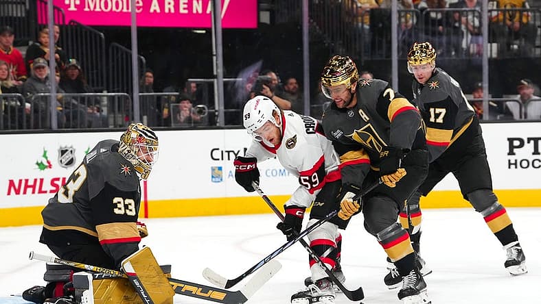Dec 17, 2023; Las Vegas, Nevada, USA; Ottawa Senators left wing Angus Crookshank (59) attempts to shoot the puck in front of Vegas Golden Knights defenseman Alex Pietrangelo (7) and defenseman Ben Hutton (17) as  goaltender Adin Hill (33) defends his net during the first period at T-Mobile Arena. Mandatory Credit: Stephen R. Sylvanie-USA TODAY Sports