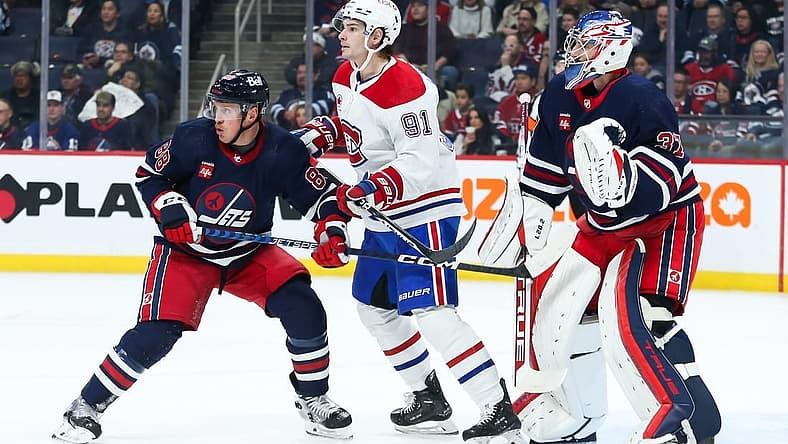 Dec 18, 2023; Winnipeg, Manitoba, CAN; Montreal Canadiens forward Sean Monohan (91) jostles for position with Winnipeg Jets defenseman Nate Schmidt (88) in front of Winnipeg Jets goalie Connor Hellebuyck (37) during the first period at Canada Life Centre. Mandatory Credit: Terrence Lee-USA TODAY Sports