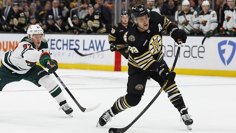 Dec 19, 2023; Boston, Massachusetts, USA; Boston Bruins right wing David Pastrnak (88) lets go with a shot in front of Minnesota Wild left wing Kirill Kaprizov (97) during the first period at TD Garden. Mandatory Credit: Winslow Townson-USA TODAY Sports