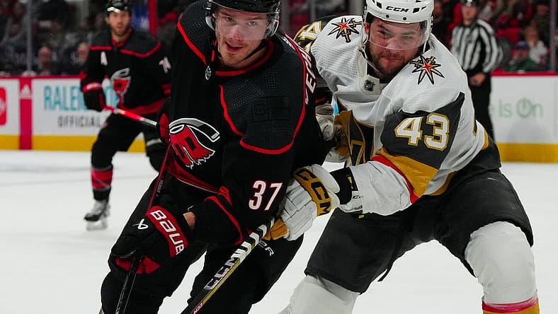 Dec 19, 2023; Raleigh, North Carolina, USA; Carolina Hurricanes right wing Andrei Svechnikov (37) and Vegas Golden Knights center Paul Cotter (43) battle for position during the first period at PNC Arena. Mandatory Credit: James Guillory-USA TODAY Sports