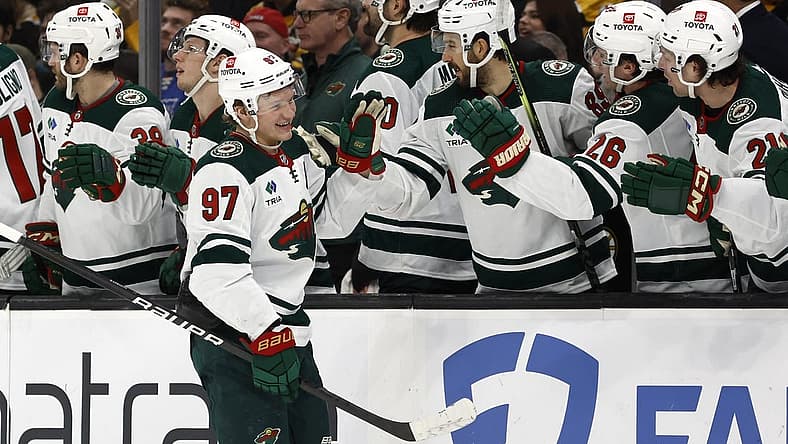 Dec 19, 2023; Boston, Massachusetts, USA; Minnesota Wild left wing Kirill Kaprizov (97) smiles as he is congratulated at the bench after scoring against the Boston Bruins during the third period at TD Garden. Mandatory Credit: Winslow Townson-USA TODAY Sports