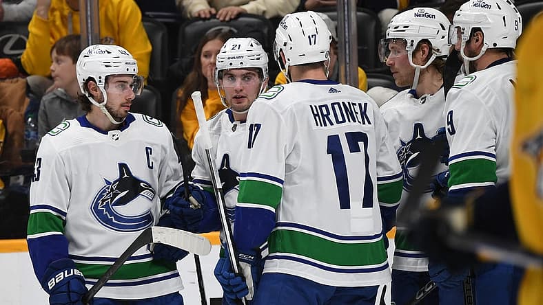 Dec 19, 2023; Nashville, Tennessee, USA; Vancouver Canucks left wing Nils Hoglander (21) celebrates with teammates after a goal during the second period against the Nashville Predators at Bridgestone Arena. Mandatory Credit: Christopher Hanewinckel-USA TODAY Sports