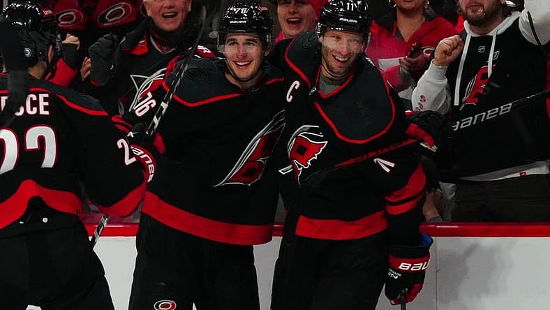 Dec 19, 2023; Raleigh, North Carolina, USA; Carolina Hurricanes defenseman Brady Skjei (76) celebrates his goal with center Jordan Staal (11) against the Vegas Golden Knights during the third period at PNC Arena. Mandatory Credit: James Guillory-USA TODAY Sports