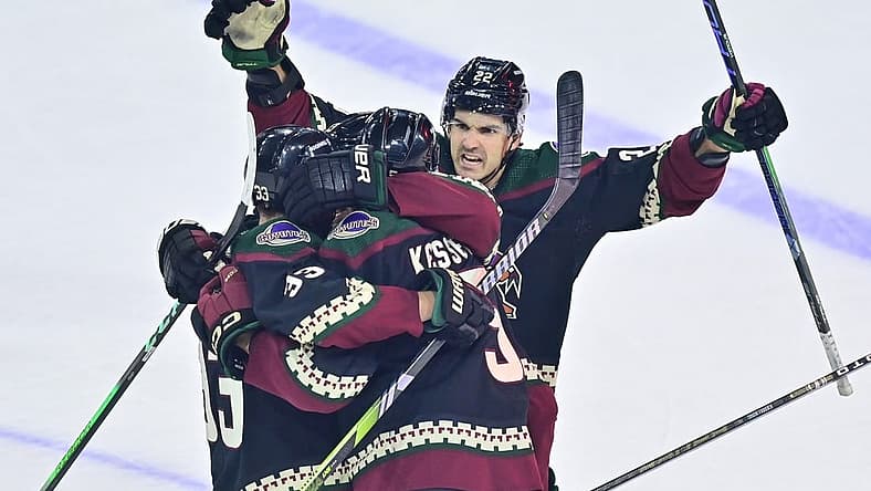 Dec 19, 2023; Tempe, Arizona, USA; Arizona Coyotes defenseman Michael Kesselring (5) celebrates with center Jack McBain (22) and defenseman Travis Dermott (33) after scoring a goal in the third period against the Ottawa Senators at Mullett Arena. Mandatory Credit: Matt Kartozian-USA TODAY Sports