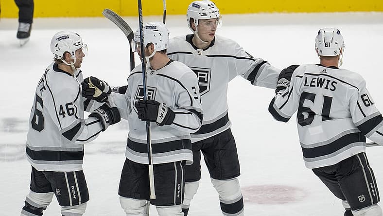 Dec 19, 2023; San Jose, California, USA; Los Angeles Kings center Trevor Lewis (61), center Blake Lizotte (46), defenseman Jacob Moverare (43) and defenseman Matt Roy (3) celebrate after a goal during the third period against the San Jose Sharks at SAP Center at San Jose. Mandatory Credit: Neville E. Guard-USA TODAY Sports