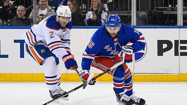 Dec 22, 2023; New York, New York, USA; Edmonton Oilers defenseman Evan Bouchard (2) defends against New York Rangers center Vincent Trocheck (16) during the second period at Madison Square Garden. Mandatory Credit: Dennis Schneidler-USA TODAY Sports