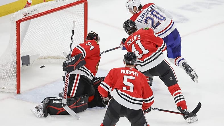 Dec 22, 2023; Chicago, Illinois, USA; Montreal Canadiens left wing Juraj Slafkovsky (20) shoots and scores against Chicago Blackhawks goaltender Petr Mrazek (34) during the second period at United Center. Mandatory Credit: Kamil Krzaczynski-USA TODAY Sports