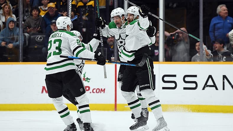 Dec 23, 2023; Nashville, Tennessee, USA; Dallas Stars defenseman Jani Hakanpaa (2) and center Craig Smith (15) celebrate with teammates after scoring the game-winning goal late in the third period to beat the Nashville Predators at Bridgestone Arena. Mandatory Credit: Christopher Hanewinckel-USA TODAY Sports