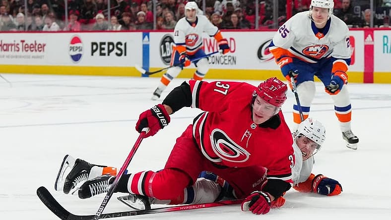 Dec 23, 2023; Raleigh, North Carolina, USA; Carolina Hurricanes right wing Andrei Svechnikov (37) is knocked off the puck during the first period at PNC Arena. Mandatory Credit: James Guillory-USA TODAY Sports