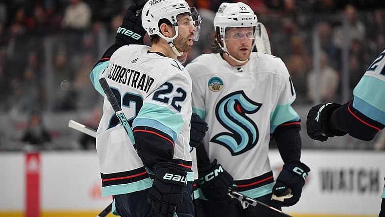 Dec 23, 2023; Anaheim, California, USA; Seattle Kraken right wing Oliver Bjorkstrand (22) celebrates his goal scored against the Anaheim Ducks with left wing Jared McCann (19) during the first period at Honda Center. Mandatory Credit: Gary A. Vasquez-USA TODAY Sports