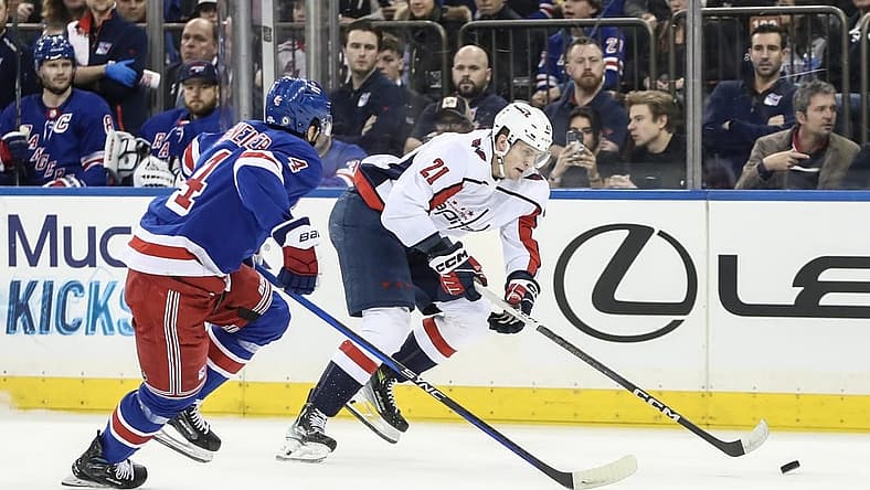 Dec 27, 2023; New York, New York, USA; Washington Capitals center Aliaksei Protas (21) skates past New York Rangers defenseman Braden Schneider (4) in the first period at Madison Square Garden. Mandatory Credit: Wendell Cruz-USA TODAY Sports