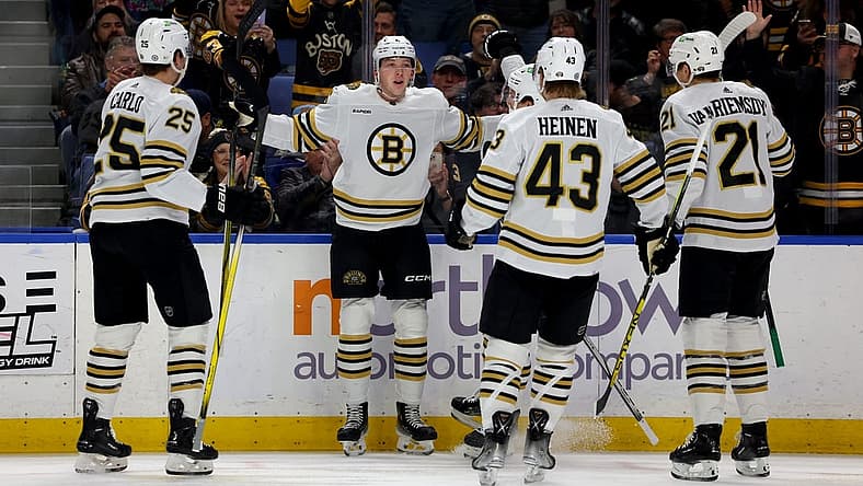 Dec 27, 2023; Buffalo, New York, USA;  Boston Bruins defenseman Mason Lohrei (6) celebrates his goal with teammates during the first period against the Buffalo Sabres at KeyBank Center. Mandatory Credit: Timothy T. Ludwig-USA TODAY Sports