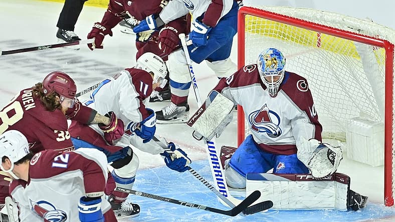 Dec 27, 2023; Tempe, Arizona, USA; Colorado Avalanche goaltender Alexandar Georgiev (40) and center Andrew Cogliano (11) defend as Arizona Coyotes center Liam O'Brien (38) attacks in the first period at Mullett Arena. Mandatory Credit: Matt Kartozian-USA TODAY Sports