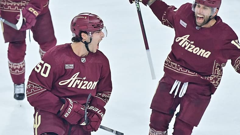 Dec 27, 2023; Tempe, Arizona, USA; Arizona Coyotes defenseman Sean Durzi (50) celebrates with left wing Jason Zucker (16) after scoring a goal in the third period against the Colorado Avalanche at Mullett Arena. Mandatory Credit: Matt Kartozian-USA TODAY Sports