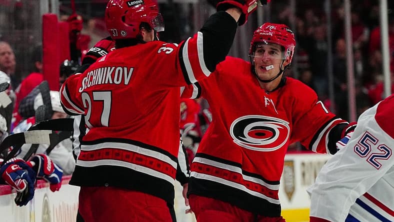 Dec 28, 2023; Raleigh, North Carolina, USA; Carolina Hurricanes right wing Andrei Svechnikov (37) celebrates his goal with defenseman Brady Skjei (76) against the Montreal Canadiens during the third period at PNC Arena. Mandatory Credit: James Guillory-USA TODAY Sports