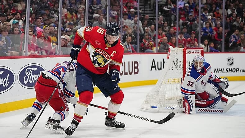 Dec 29, 2023; Sunrise, Florida, USA; Florida Panthers center Aleksander Barkov (16) controls the puck against the New York Rangers during the second period at Amerant Bank Arena. Mandatory Credit: Jasen Vinlove-USA TODAY Sports