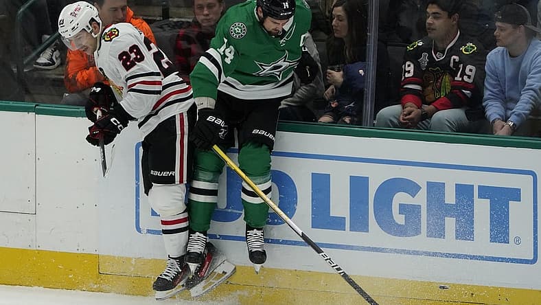 Dec 29, 2023; Dallas, Texas, USA; Chicago Blackhawks center Philipp Kurashev (23) takes Dallas Stars left wing Jamie Benn (14) off the puck during the first period at American Airlines Center. Mandatory Credit: Raymond Carlin III-USA TODAY Sports